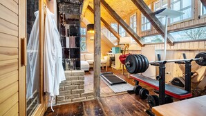 A wooden interior with a staircase, a bench, and a weightlifting area. - Holiday Home 'Seeblick' with Lake View, Private Terrace and Wi-Fi (Rheinsberg)