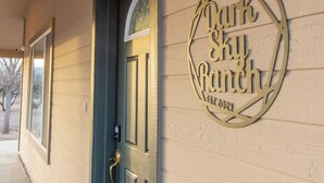 A building entrance with a door and a sign that reads "Dark Sky Ranch EST 2021". - Dark Sky Retreat Near Sedona • Hot Tub, Sauna & Mountain Views (Cornville)