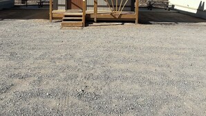 A small wooden building with a porch, a door, and a window. - Wild West Cabin Suite (Quartzsite)