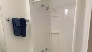 A bathroom with a toilet, sink, bathtub, and shower. - Value Stay Clean Room at Castle Motel (Edson)