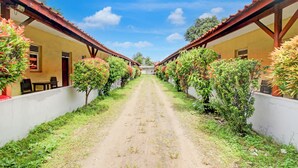 A pathway flanked by two buildings with a clear sky above. - Collection O Stasiun Pekalongan Near Stasiun Kereta Api Formerly Hotel Indah (Pekalongan)