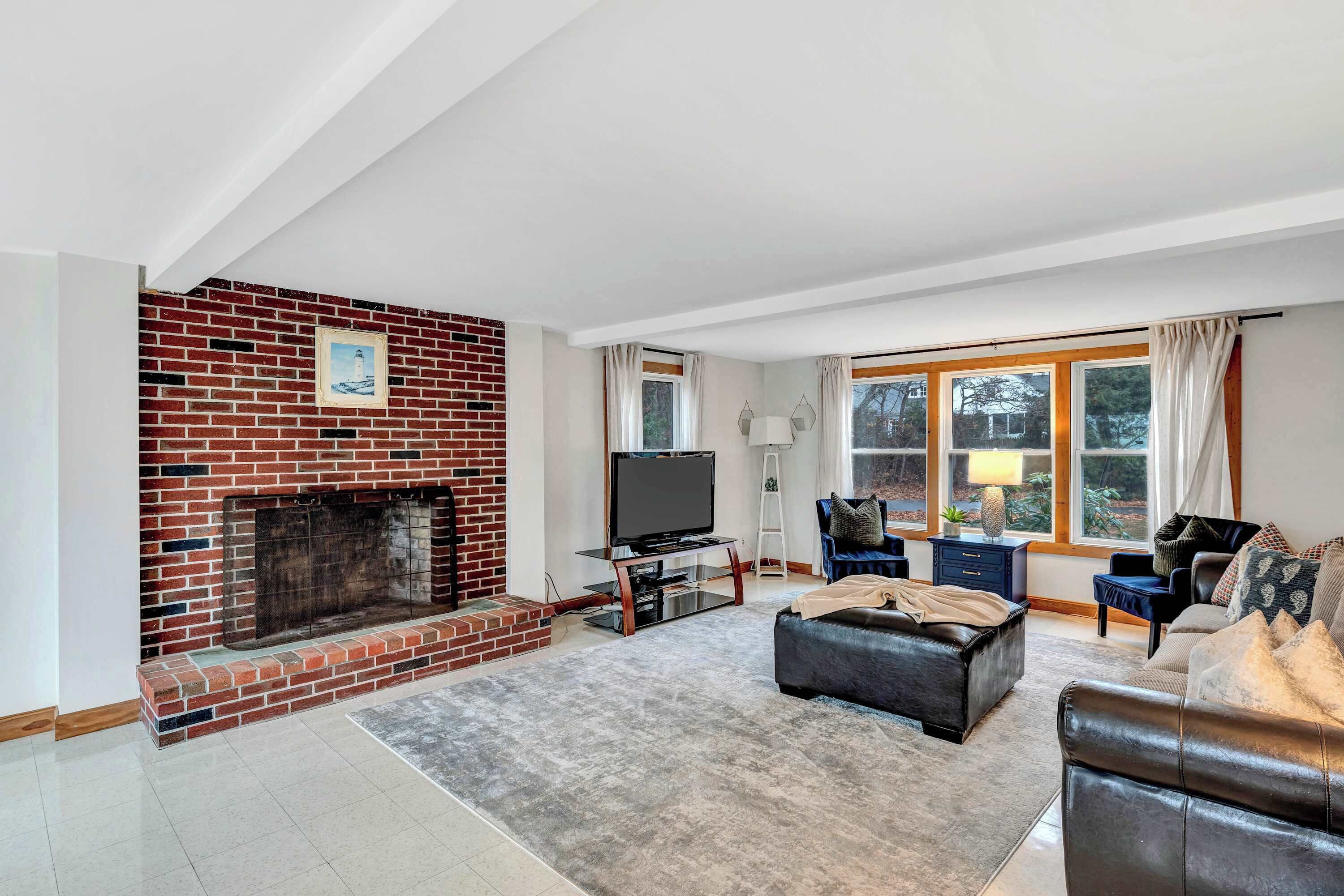 Enjoy cozy evenings by the fireplace in this beautifully designed living space, perfect for relaxation and entertainment.