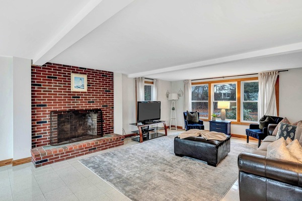 Enjoy cozy evenings by the fireplace in this beautifully designed living space, perfect for relaxation and entertainment.