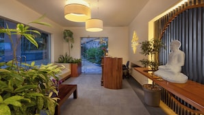 A modern hotel lobby with a reception desk, seating area, and a Buddha statue. - Cassendra Kandy (Kandy)