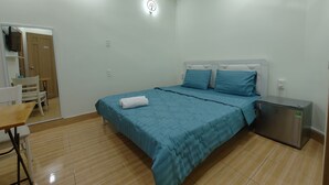 A bedroom with a bed, a desk, and a chair. - D Home (Ho Chi Minh City)