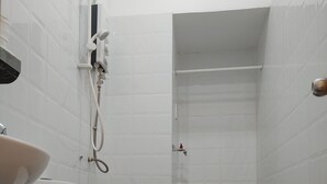 A bathroom with a toilet, sink, and shower. - D Home (Ho Chi Minh City)