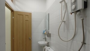 A bathroom with a toilet, sink, and shower. - D Home (Ho Chi Minh City)