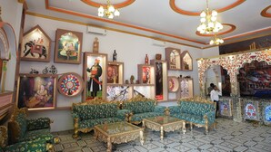 A traditional room with ornate furniture, decorative wall art, and chandeliers.