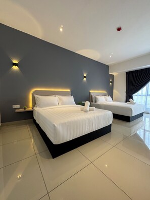 A modern hotel room with two beds, a large window with curtains, and wall-mounted lighting. - Maca Hotel by Sky Hive (George Town)