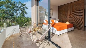 A modern bedroom with a large window, a bed with orange bedding, and a wooden wall panel.