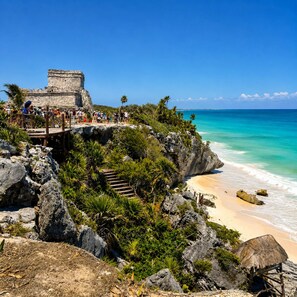 A coastal view with a stone structure and a beach.