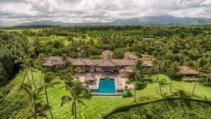 A large resort with multiple buildings, a swimming pool, and lush greenery. - Hale Ae Kai in Kilauea (Kilauea)