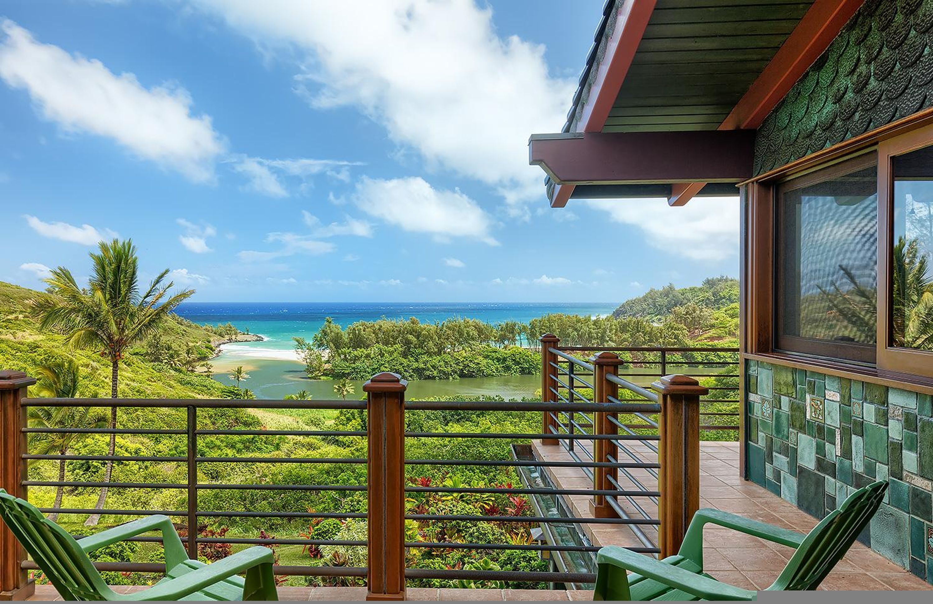 Un balcon avec vue sur une plage et l’océan.