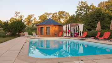 Seasonal outdoor pool, open 10:00 AM to 9:00 PM, pool umbrellas