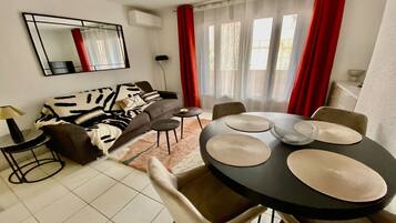 Standard Apartment, 2 Bedrooms, Garden View | Living area | 65-inch flat-screen TV with cable channels