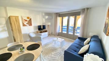 Standard Apartment, 1 Bedroom, Garden View | Living area | 65-inch flat-screen TV with cable channels