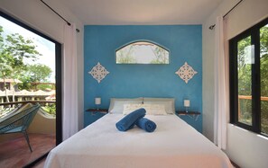 A bedroom with a large bed, two bedside tables, a window, and a view of the outdoors. - Villa Ataraxia Solferino  (Solferino)