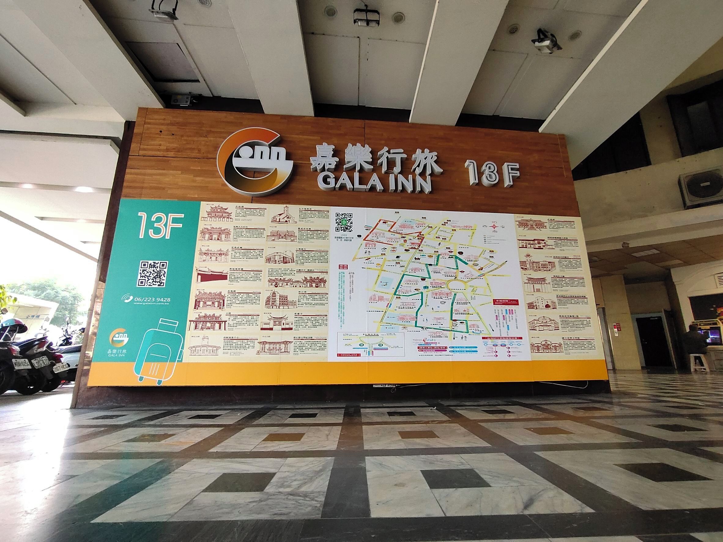 A hotel sign with a map and QR code.
