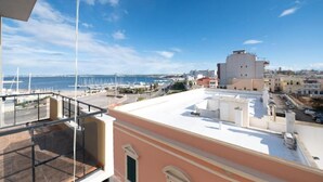 A rooftop terrace with a view of the marina and cityscape.
