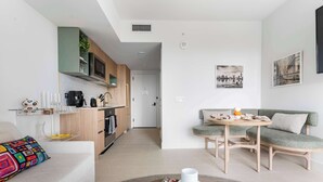 A modern living space with a kitchen, dining area, and seating. - RumRunner, Downtown, Pool, Gym, Full Service Tower (Miami)