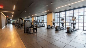 A gym with cardio machines, weight equipment, and large windows. - RumRunner, Downtown, Pool, Gym, Full Service Tower (Miami)