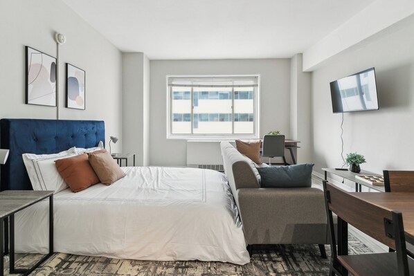 Desk, iron/ironing board, travel crib, bed sheets