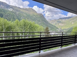 A balcony with a view of a mountainous landscape.