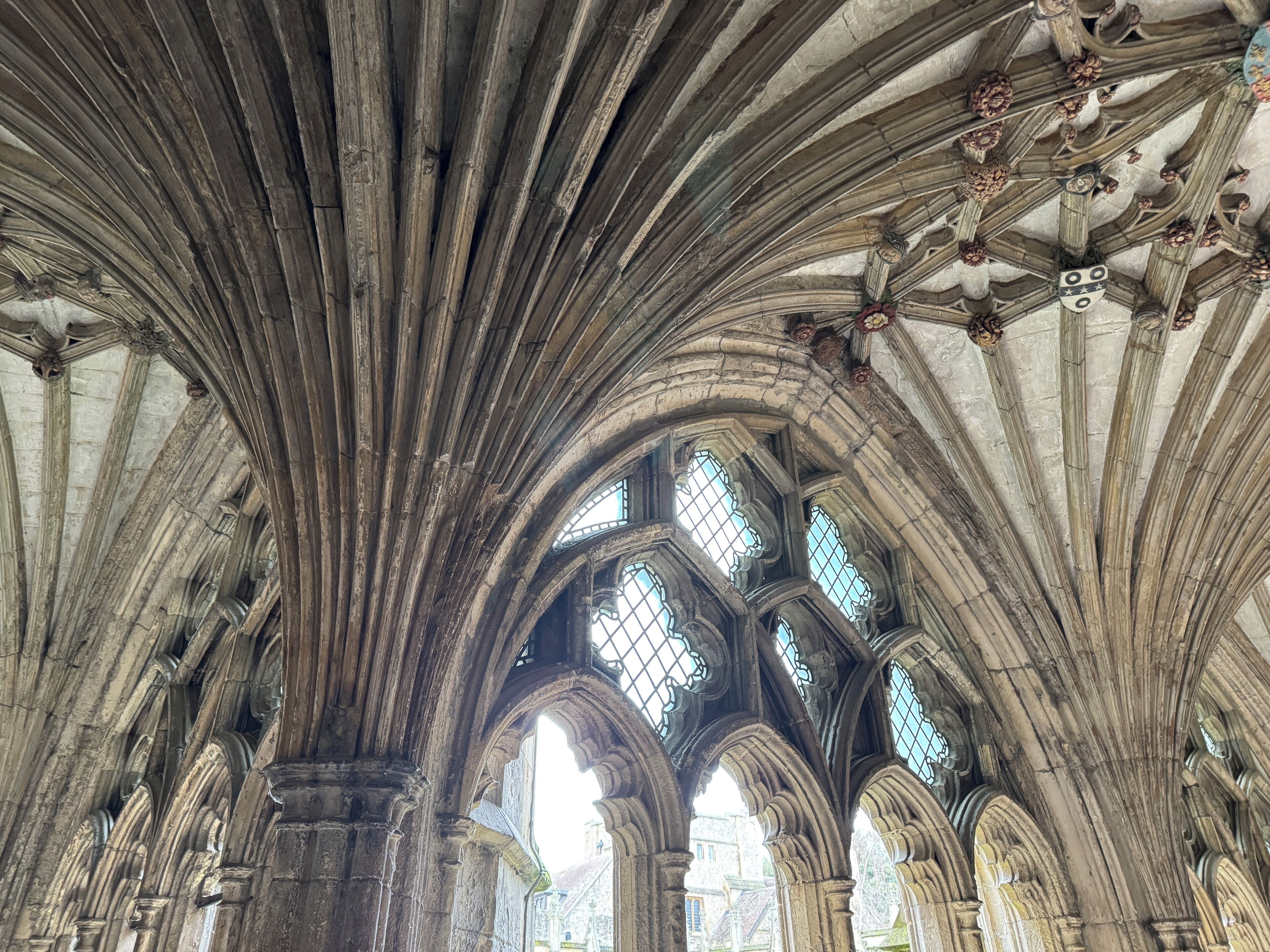 A cathedral interior with high vaulted ceilings, pointed arches, and stained glass windows.