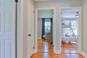 A hallway with a wooden floor leading to a room with a bunk bed and a desk. - Aralia-5Min. to Williams-Brice/10Min. to Ft.Jackson (Columbia)