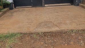 A gated entrance labeled "ALPHA GUEST HOUSE" with a metal gate and a concrete floor. - ALPHA RETREAT (Kisumu)