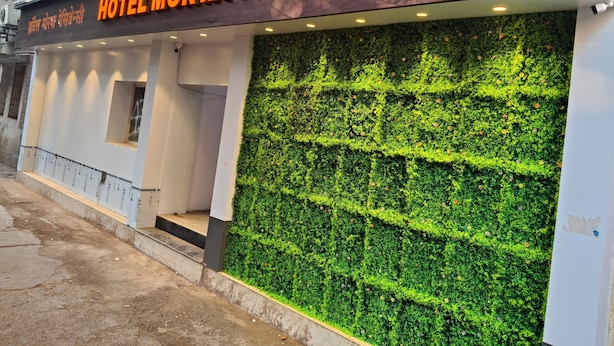 A hotel named 'Hotel Morya Residency' with a modern facade, a green vertical garden, and a clean entrance area. - Hotel Morya Residency Parel (Mumbai)