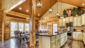 A spacious kitchen with wooden walls, a large island, and modern appliances.