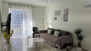 Premier Apartment, Courtyard View | Living room | 160-cm TV with cable channels, streaming services