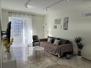 Premier Apartment, Courtyard View | Living room | 160-cm TV with cable channels, streaming services