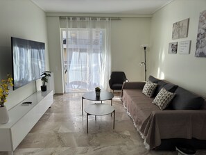 Premier Apartment, Courtyard View | Living room | 160-cm TV with cable channels, streaming services