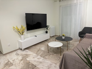 Premier Apartment, Courtyard View | Living room | 160-cm TV with cable channels, streaming services