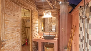 A wooden cabin bathroom with a large mirror, a sink, and a shower. - Villa Palma Gili Meno (Gili Meno)