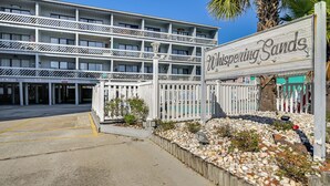 A multi-story hotel with a sign reading "Whispering Sands." - Walk to Beach: Top-floor Condo in Murrells Inlet (Murrells Inlet)