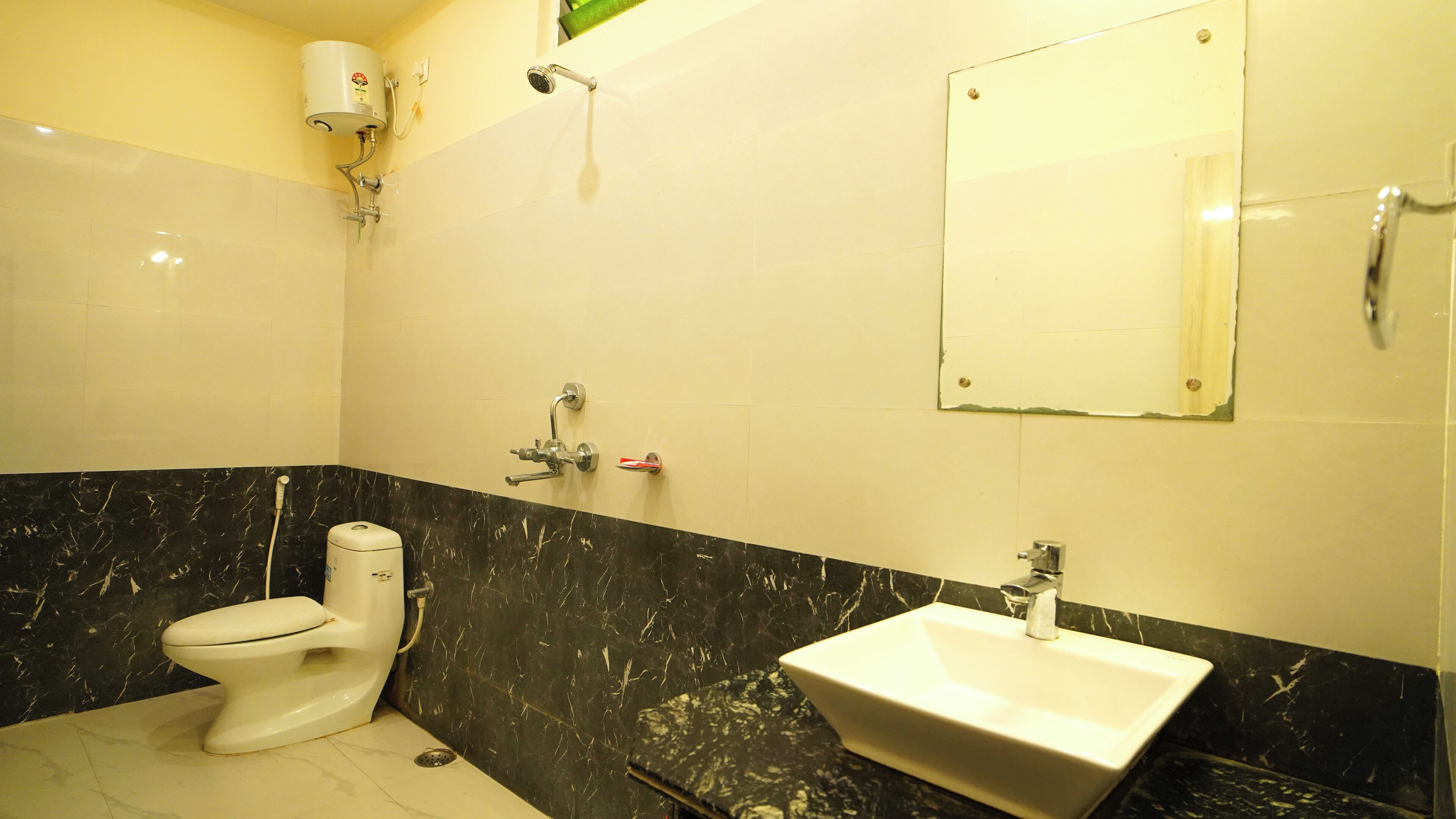 A bathroom with a toilet, sink, and shower.