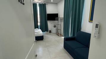 Deluxe Quadruple Room, City View | Desk, blackout curtains, iron/ironing board, free WiFi