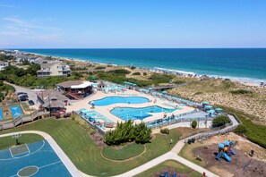 Relax by the resort's central pool, surrounded by decks, a basketball court, and a playground.