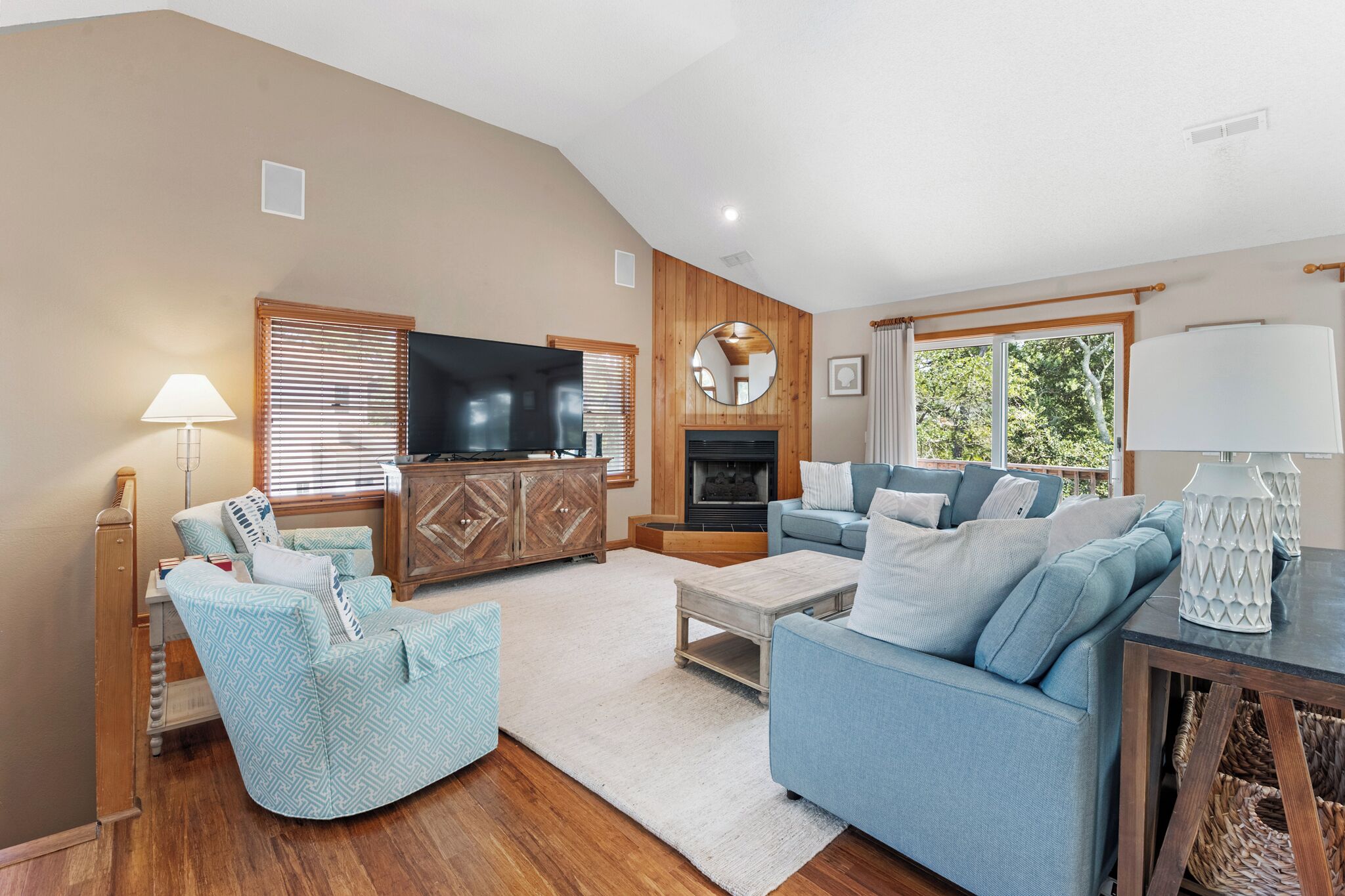 A living room with a fireplace, a television, a sofa, and a coffee table.