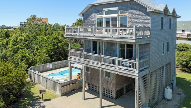 A two-story house with a balcony, a swimming pool, and a hot tub. - Ocean's 11: Private Pool | Hot Tub | Game Room (Salvo)
