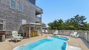 A backyard with a swimming pool, outdoor furniture, and a wooden deck. - Ocean's 11: Private Pool | Hot Tub | Game Room (Salvo)