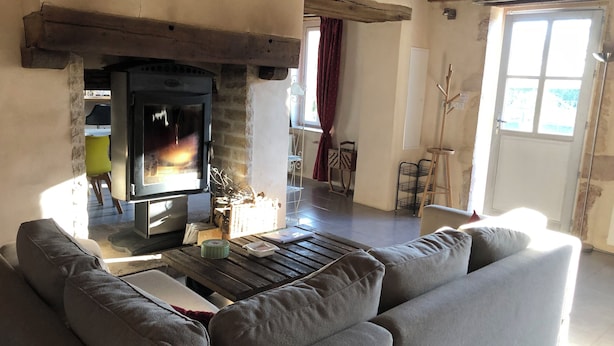 A cozy living room with a fireplace, a sofa, and a coffee table.