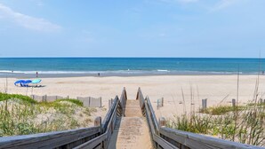 A wooden boardwalk leading to a sandy beach with a clear blue sky. - Sea Spot: Saltwater Pool, Hot Tub, Beach Club Access (Corolla)