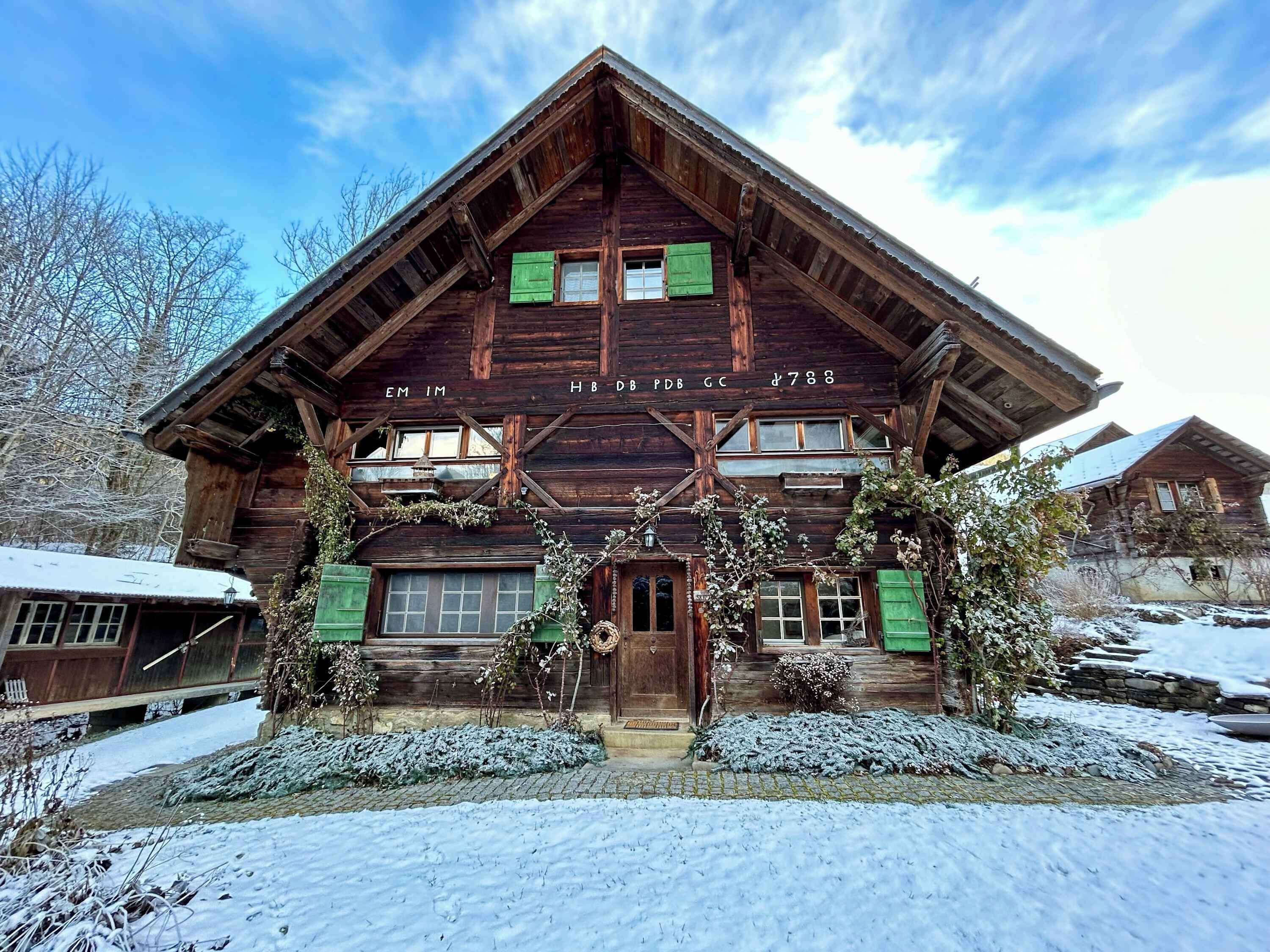 the beautiful chalet from front yard on a snowy winter day