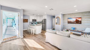 A modern kitchen with white cabinets, stainless steel appliances, and a central island. - Seahorse Suites #3. Island Living at it's Best! (Sanibel)