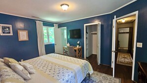 A bedroom with a large bed, a desk, and a television. - The Marigold Cottage: Serene Mountain Getaway w/ Fire Pit, Large Yard (Highlands)