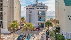 A beachfront hotel with a balcony, a beachside view, and a parking area. - Barefoot Landing 2BR/2BA at Willow Bend 822. Water View with Pool (North Myrtle Beach)